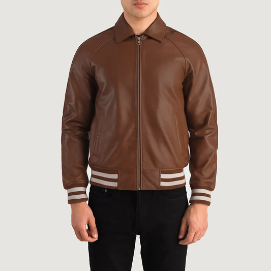 Front view of a man modeling a smooth brown leather jacket, showing the pointed collar and sporty white-and-brown striped ribbing.