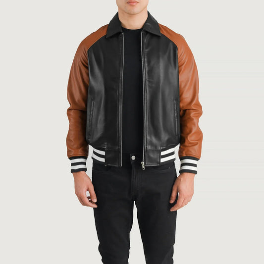 Front view of a black leather jacket with brown leather raglan sleeves, a brown shirt collar, and sporty striped knit cuffs.