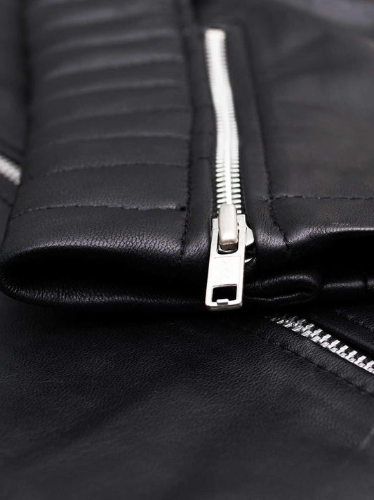 Front view of a rich black leather motorcycle jacket for women, showing silver hardware, zipper pockets, and a wide collar.