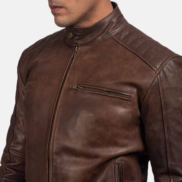 Front view of a man wearing an open dark brown leather jacket, showing the stand collar, zippered chest pocket, and quilted shoulder panels.