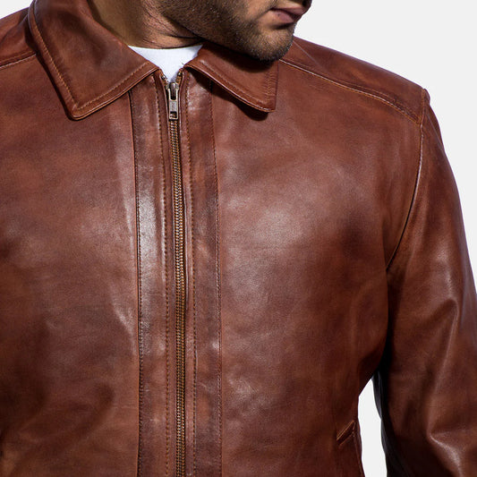 Front view of a man modeling an open rich brown leather jacket, showing the fold-down shirt collar and subtle side pockets.