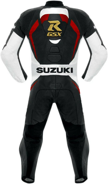 Detailed view of the gold Suzuki GSX logos, white Suzuki chest branding, and professional black knee sliders on a leather track suit.