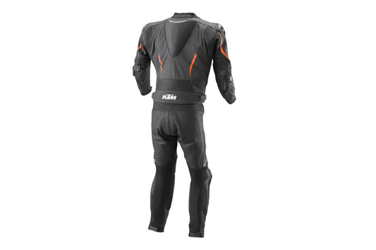 Detailed view of the KTM chest logo, dynamic padded torso plating, and professional track sliders on a black leather suit.