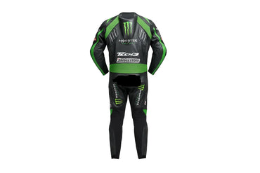 Detailed view of the Monster Energy claw logo, Tech3 forearm branding, and green accordion stretch panels on a professional one-piece racing suit.