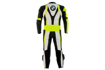 Detailed view of the BMW Motorrad chest branding, neon yellow high-visibility panels, and black accordion stretch sections on a racing suit.
