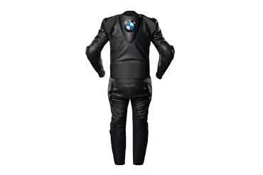 Detailed view of the BMW chest logo, perforated leather panels, and black accordion stretch sections on a professional racing suit.