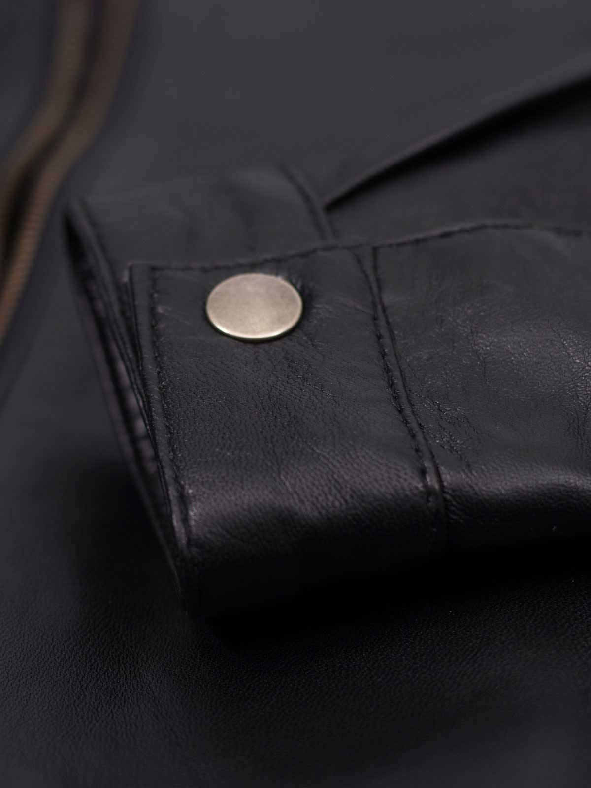 Tailored black leather jacket with quilted shoulders, offering a flattering fit and authentic biker style.