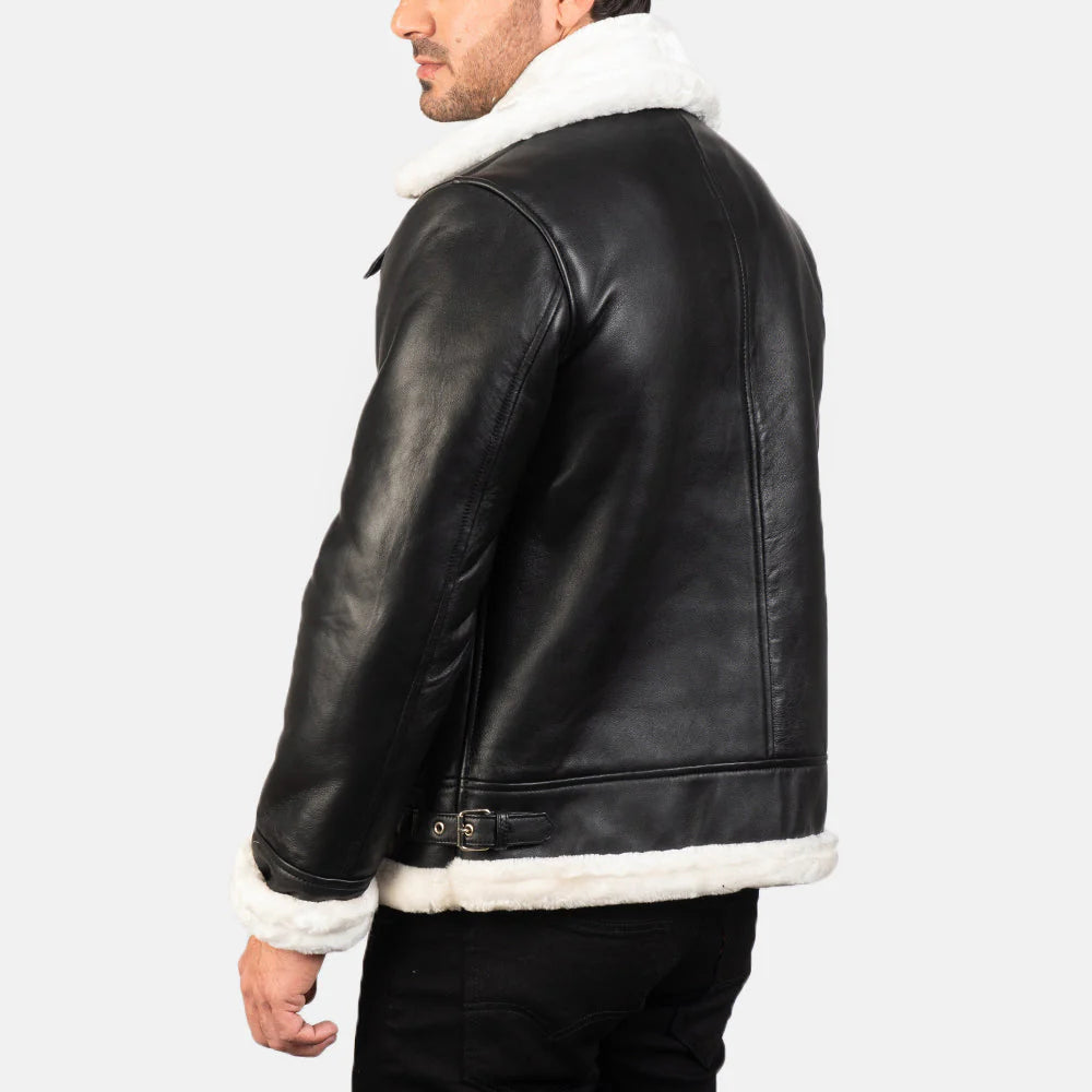 Asymmetrical black leather jacket with white shearling trim and adjustable collar buckle.