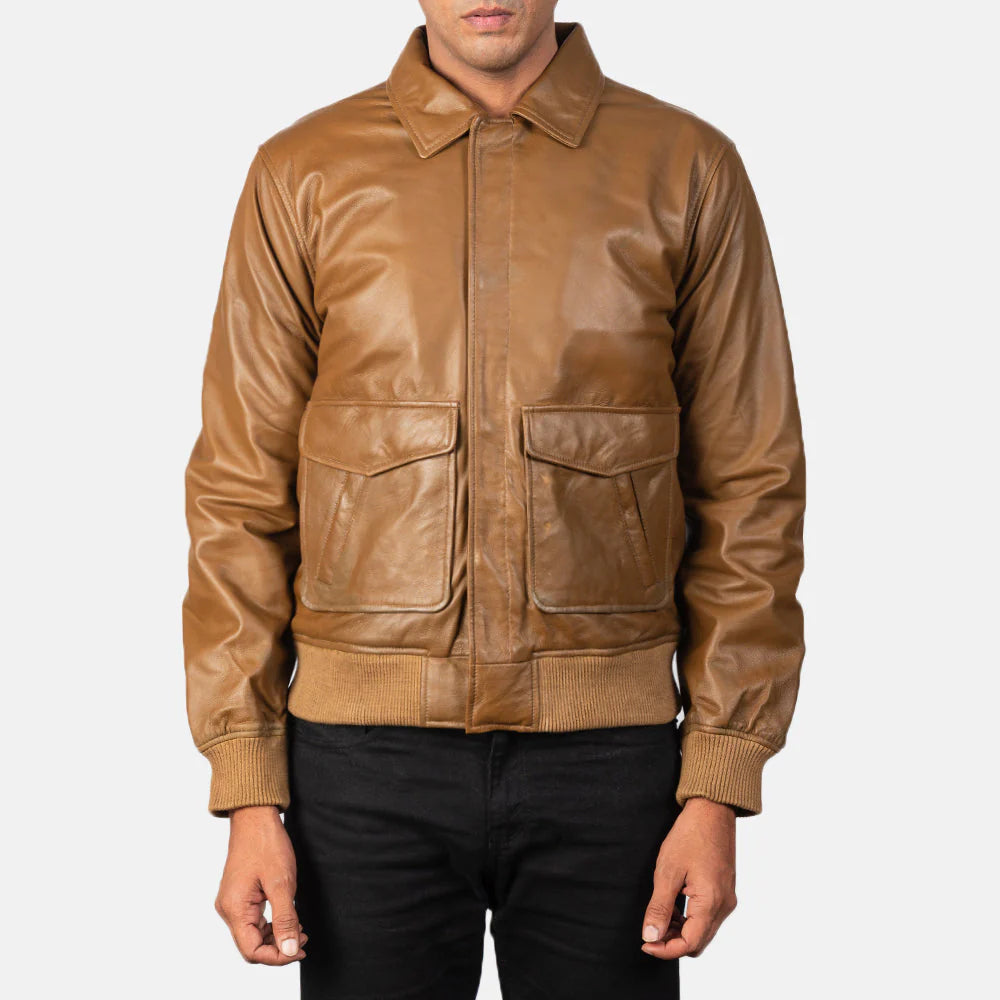 Front view of a smooth tan leather jacket on a man, showcasing the pointed shirt collar, zippered front, and ribbed waist hem.