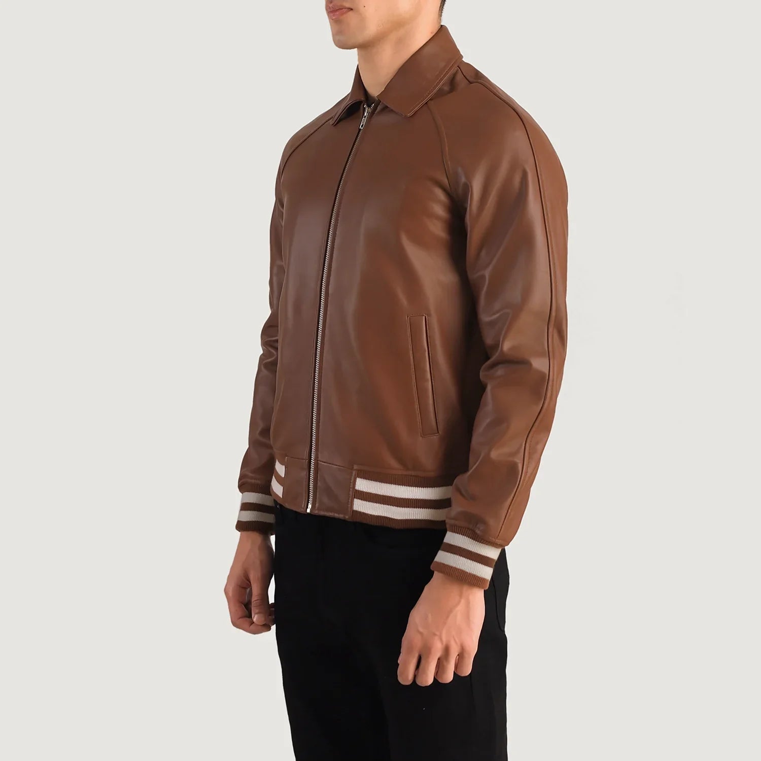 Stylish brown leather bomber jacket for men, featuring a retro varsity look with striped trim for a comfortable, sporty style.