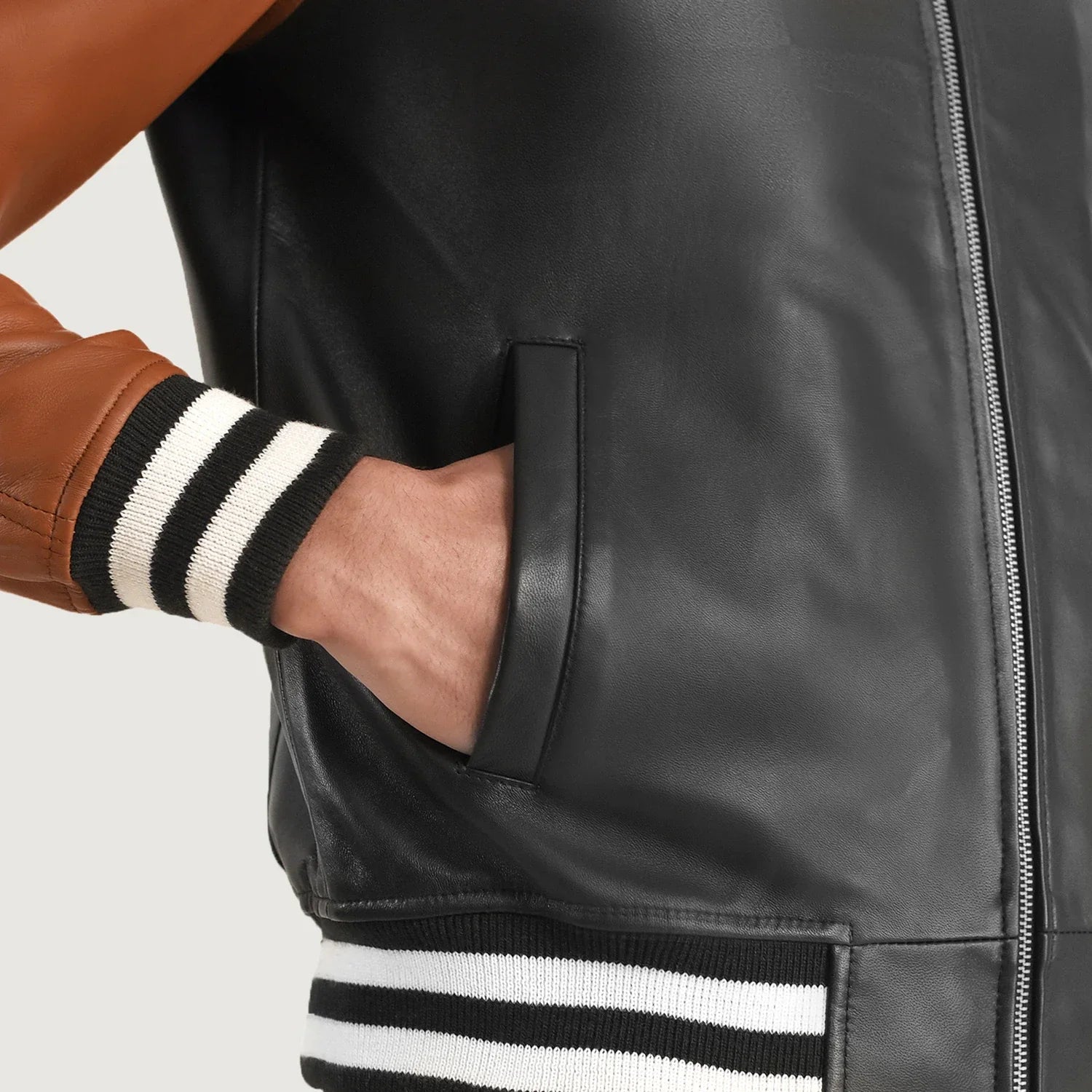 Black and brown color black leather jacket. Varsity bomber, striped cuffs, shirt collar.