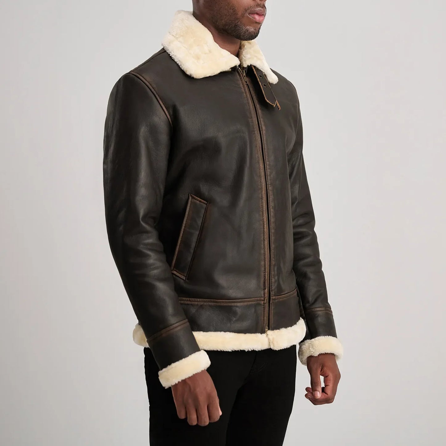Rear view of warm brown leather shearling jacket, emphasizing the full coverage of the white wool lining for cold weather.
