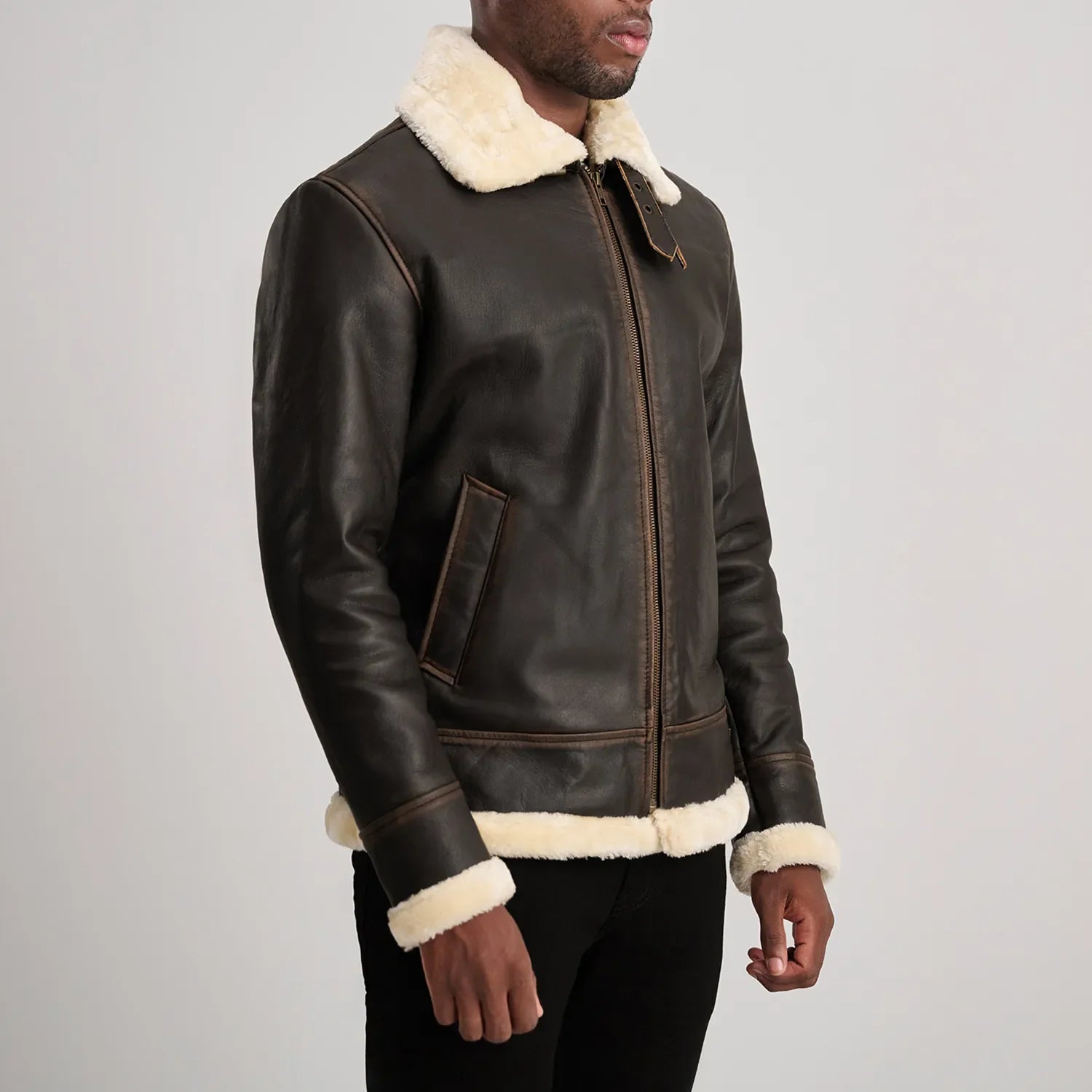 Rear view of warm brown leather shearling jacket, emphasizing the full coverage of the white wool lining for cold weather.
