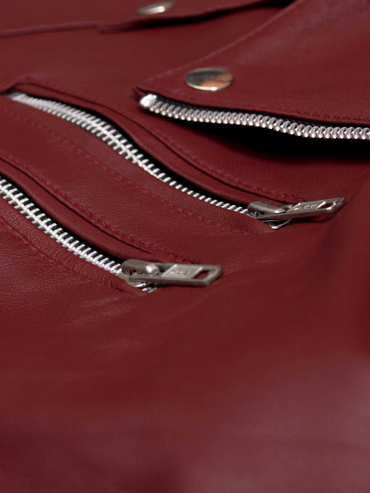 Sleek women's moto jacket in cognac brown leather, offering a tailored fit and stand collar for a modern, edgy look.