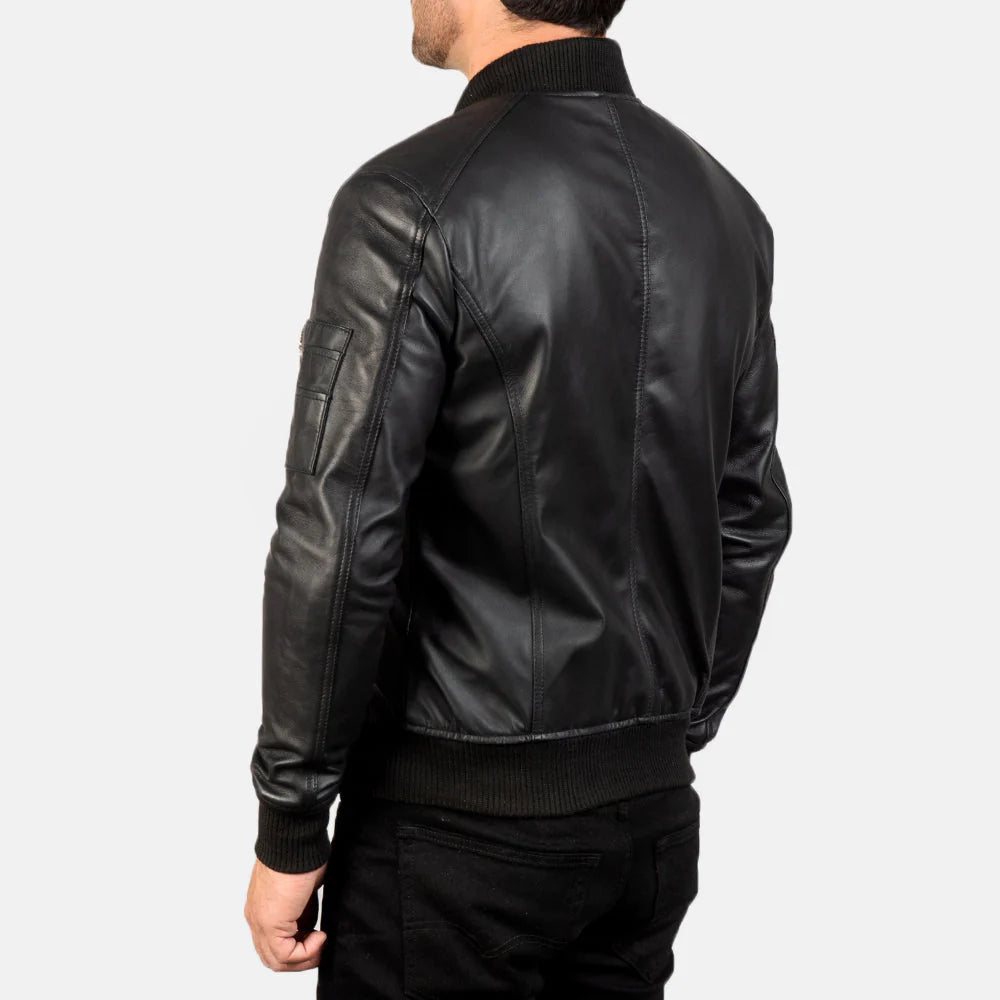 Smooth black leather bomber jacket with contrasting ribbed knit collar, cuffs, and hem, and a functional zippered arm pocket.