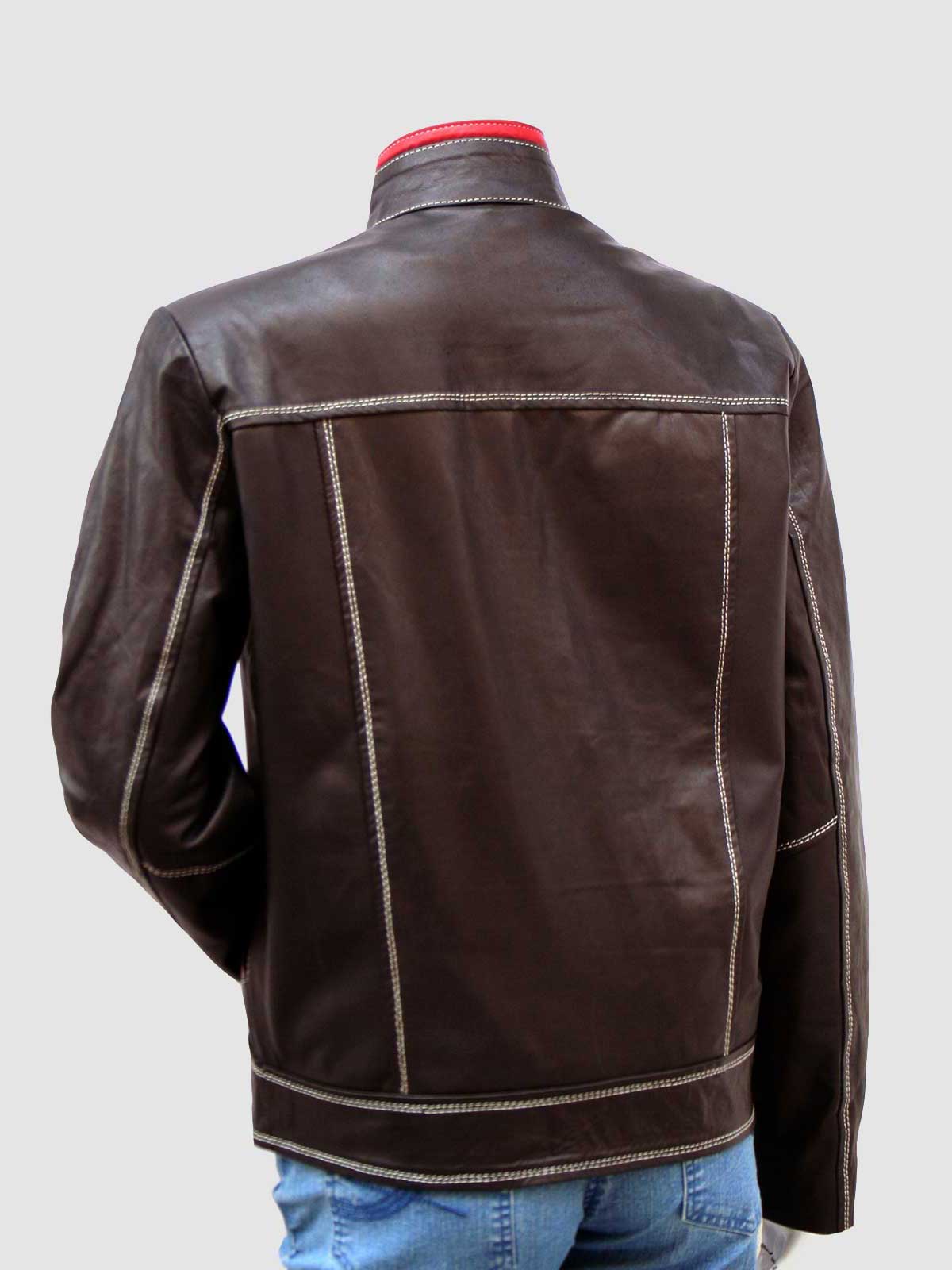 Close-up of a women's leather jacket in dark brown, featuring red trim on the collar and chest, and highly visible white stitching throughout.