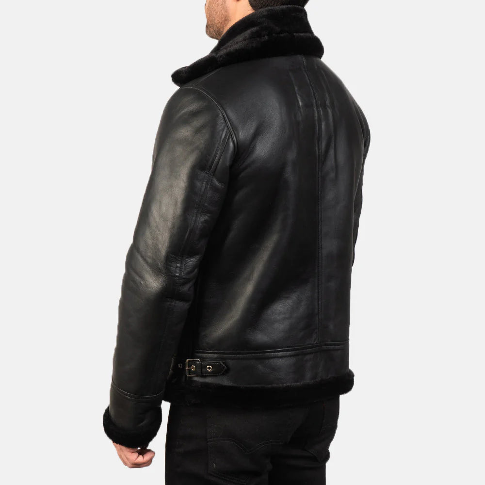 Black leather motorcycle jacket with  shoulders, asymmetrical zip, and diamond quilted patches on the sleeves.