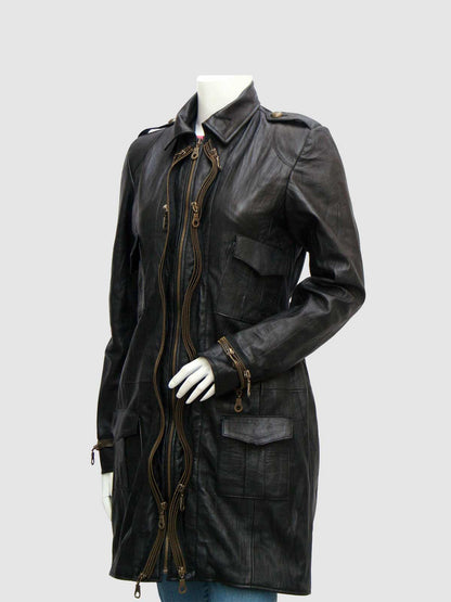 Front view of a black leather duster coat featuring a zipper cluster closure, collar, shoulder epaulets, and four patch/flap pockets.