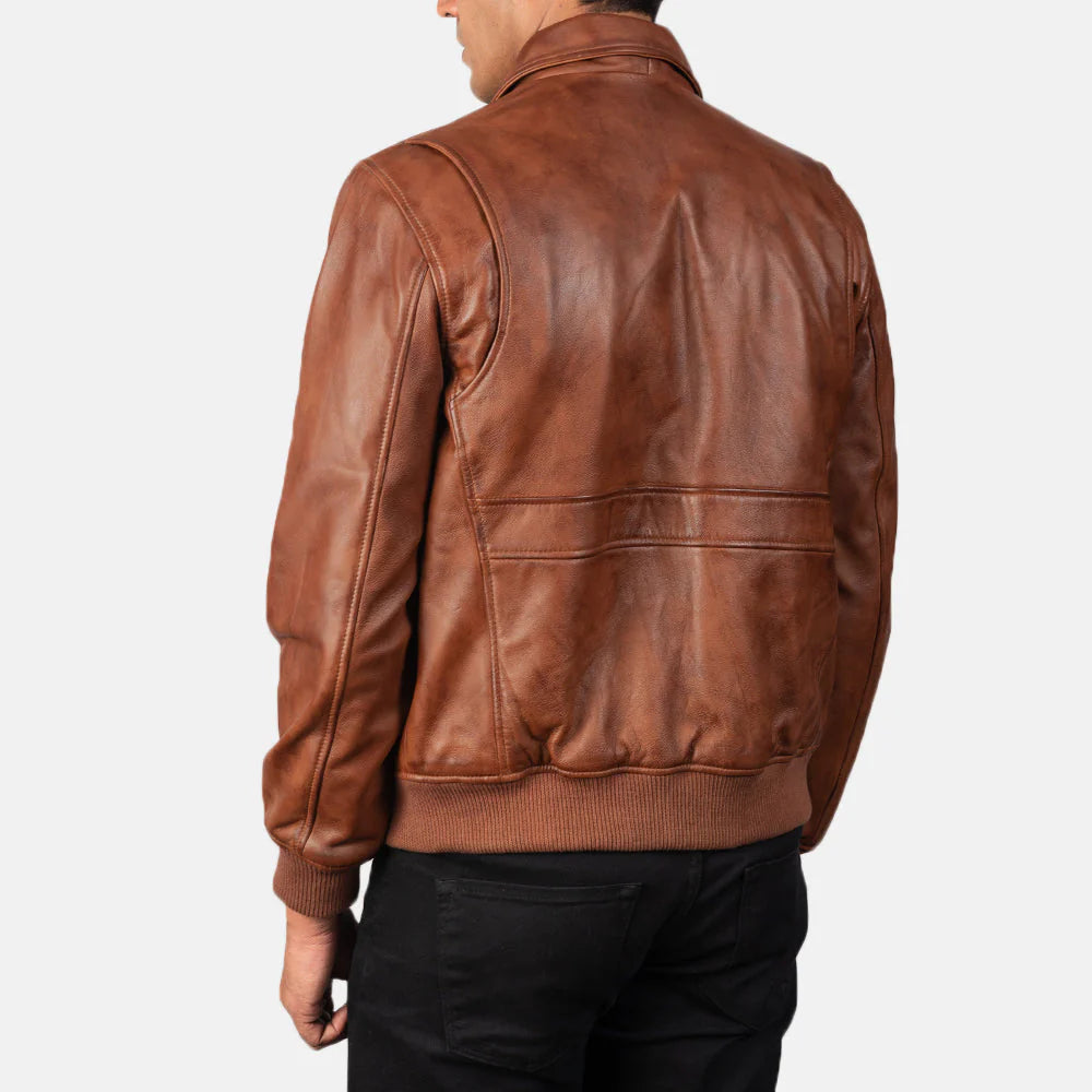 Robust brown leather jacket with a large fur lapel, asymmetrical zipper, and adjustable leather buckles on the collar.