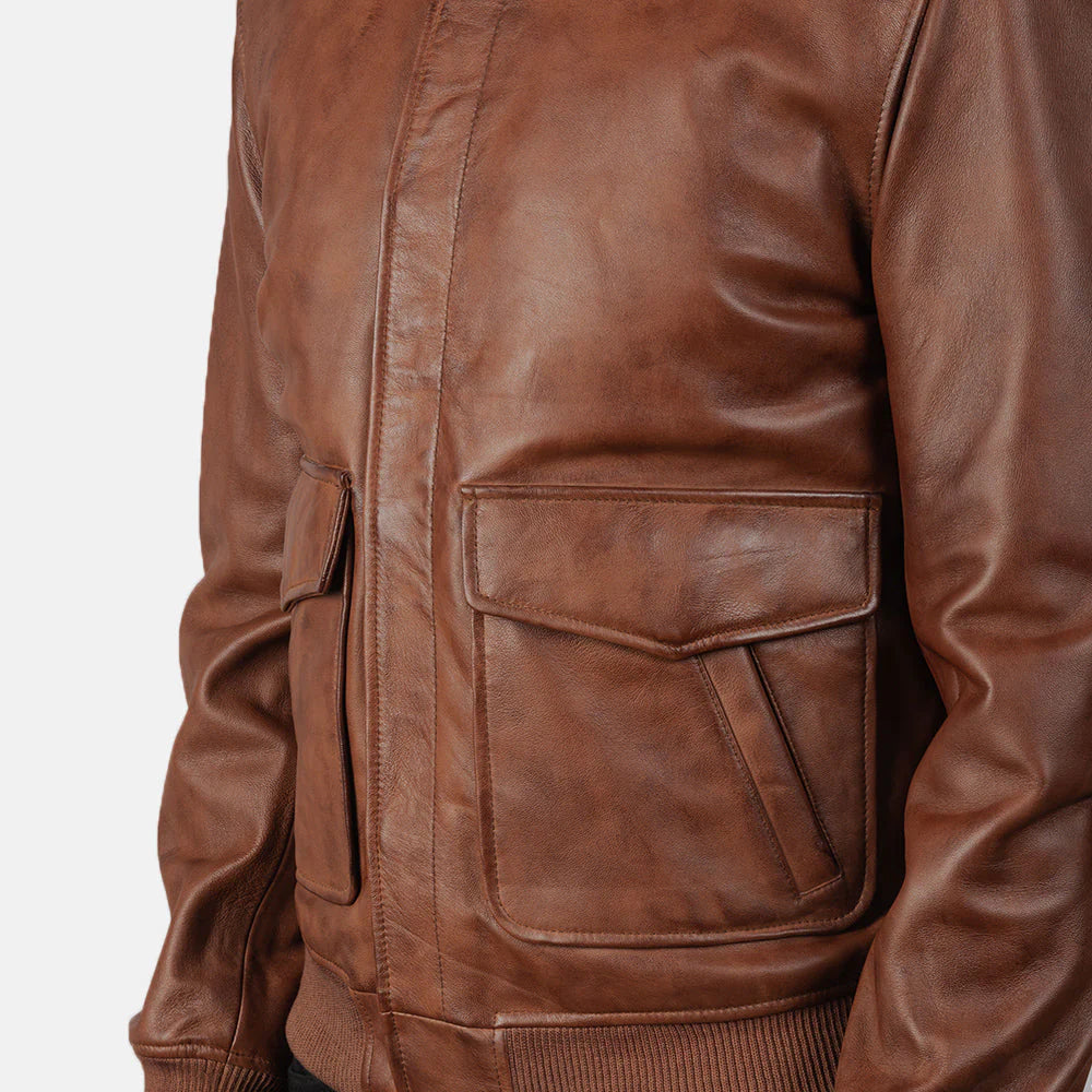 Front view of a brown sheepskin leather jacket, featuring a wide brown fur collar, exposed shearling trim, and an asymmetrical zip closure.