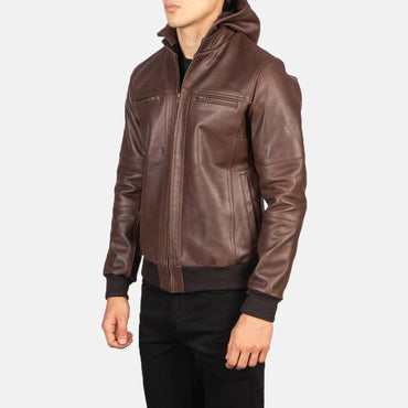 Front view of a brown suede jacket featuring a snap-button front closure, pointed stand collar, and two large lower flap pockets.