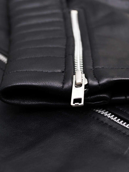 Front view of a rich black leather motorcycle jacket for women, showing silver hardware, zipper pockets, and a wide collar.