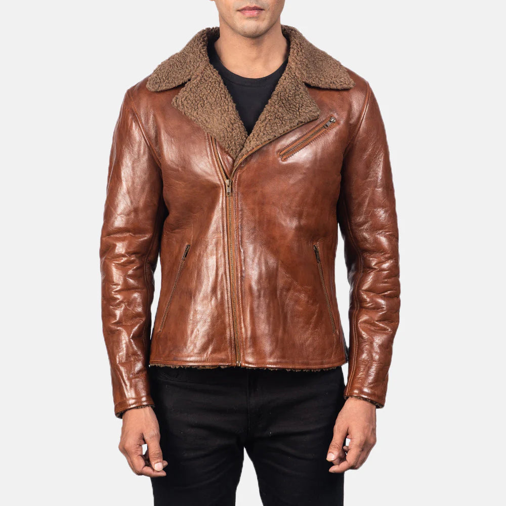 Front view of a man modeling an open brown leather moto jacket with a plush brown sherpa collar, asymmetrical zip, and a rugged, distressed finish.