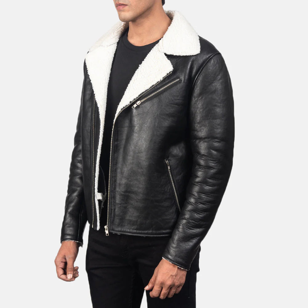 "Front view of a man wearing an open black leather moto jacket featuring a prominent white sherpa fur collar and interior, with a black t-shirt underneath."