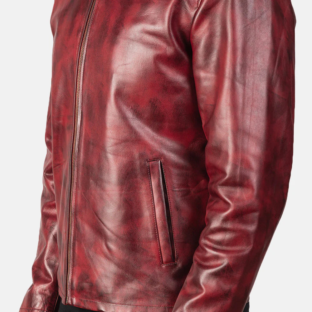 Front view of a man modeling an open burgundy leather jacket with a stand collar, showing the distressed texture and rich red-brown coloring.