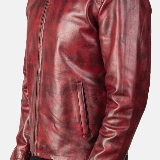 Front view of a man modeling an open burgundy leather jacket with a stand collar, showing the distressed texture and rich red-brown coloring.