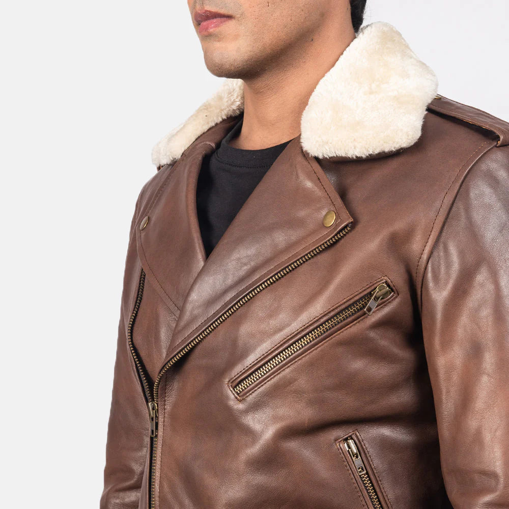 Front view of a man modeling an open brown leather motorcycle jacket with a white faux fur collar, asymmetrical zip, and functional waist belt.