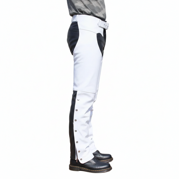 Close-up of the silver ankle snaps and articulated knee seaming on white and black leather biker overpants.