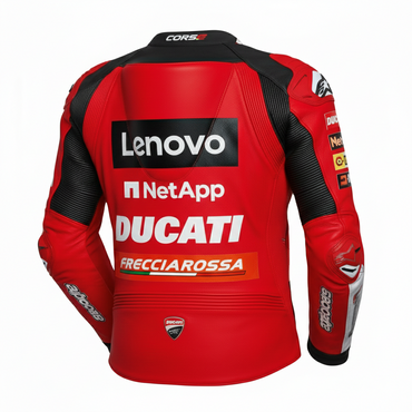 Detailed view of the Ducati Lenovo chest branding, Shell and NetApp sponsor patches, and technical leather panels on a racing red jacket.