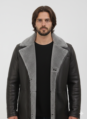 Mid-length black leather winter coat for men featuring plush grey fur trim and a vertical zip closure.