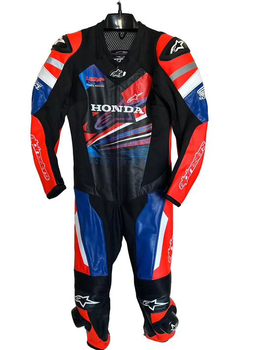 Honda HRC one-piece leather motorcycle racing suit in red, blue, and black with Alpinestars logos.