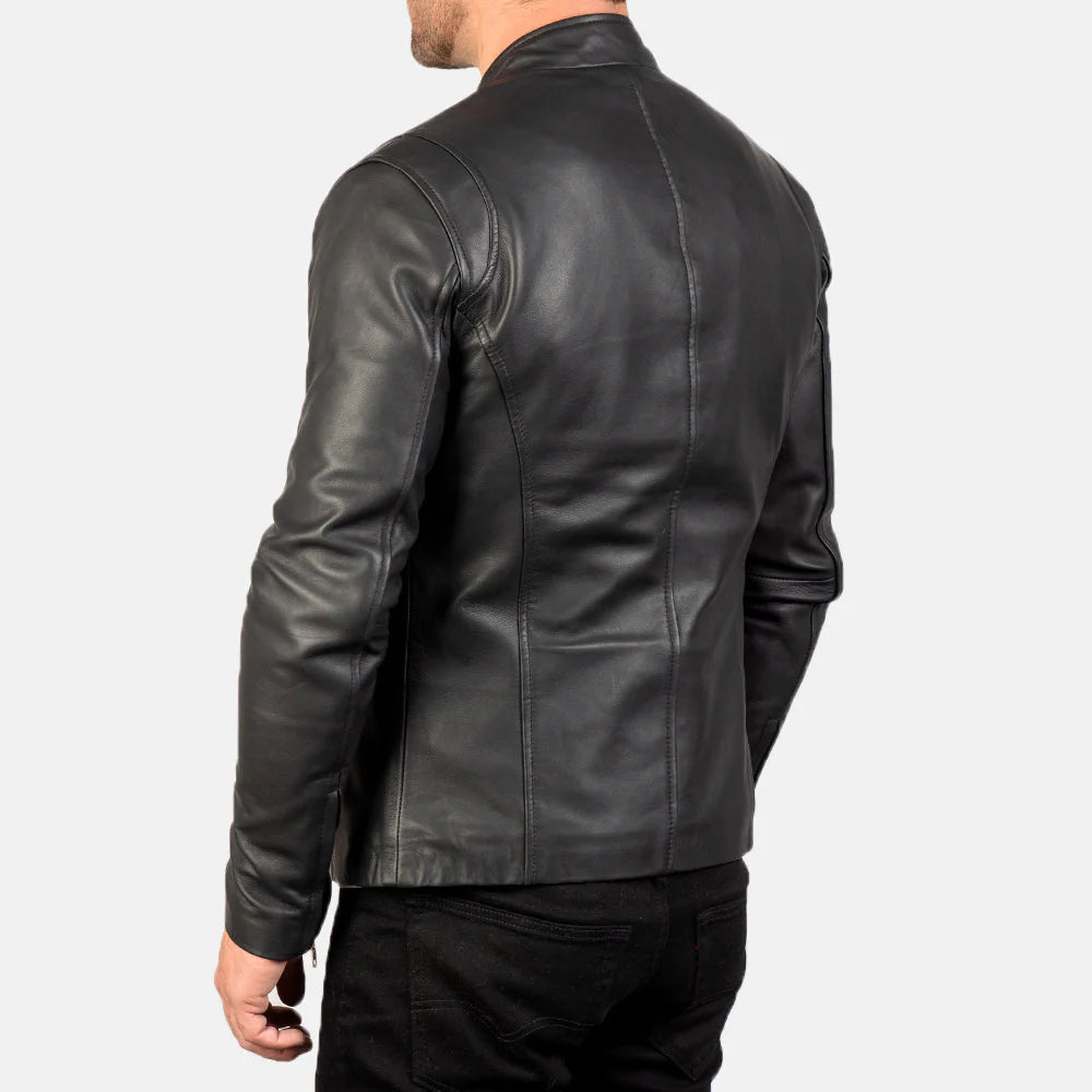 Smooth black leather jacket with a subtle sheen, featuring silver-tone zippers and a structured stand collar, worn by a man