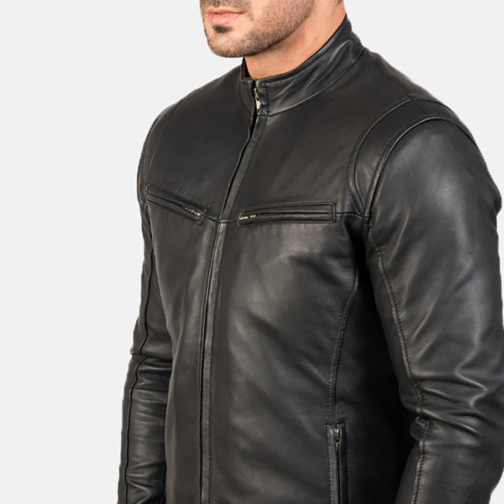Front view of a man modeling an open black leather jacket, showing the snap-button stand collar, horizontal zippered chest pockets, and a white t-shirt underneath.