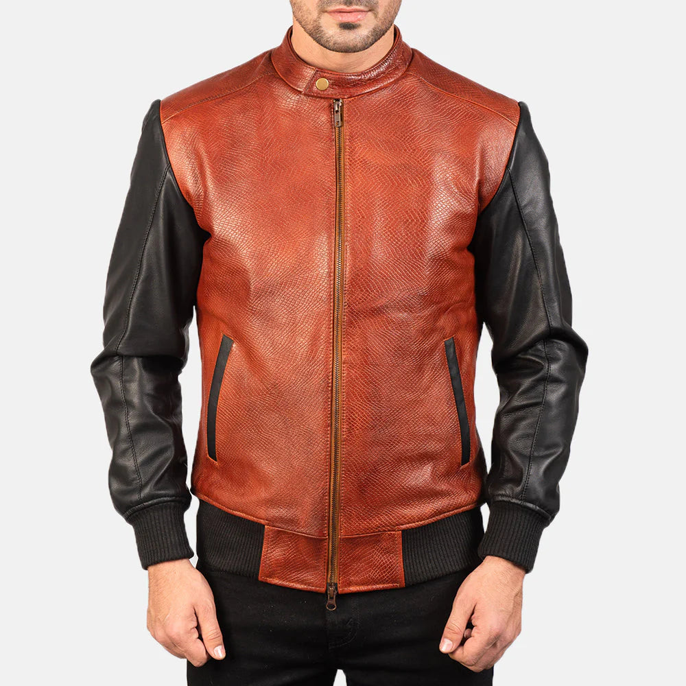 Front view of a man modeling an open two-tone leather bomber, showing the textured red body, black sleeves, and ribbed cuffs.