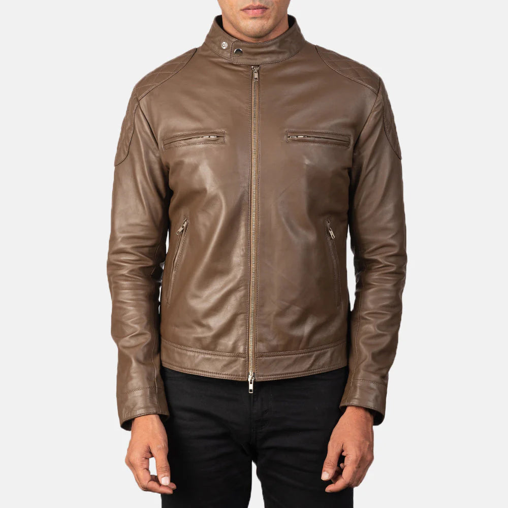 Front view of a man modeling a mocha brown leather jacket, fully zipped, showing the snap-button collar and horizontal zippered pockets.