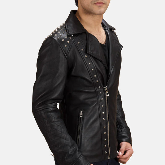 Front view of a man modeling an open black leather jacket, showing the studded lapels, asymmetrical zipper, and diamond quilted sleeves.