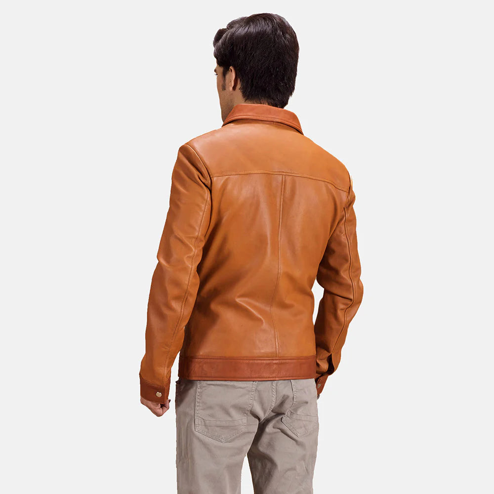 Front view of a man modeling a tan brown leather jacket, showing the contrasting darker brown panels, shirt collar, and two waist patch pockets.