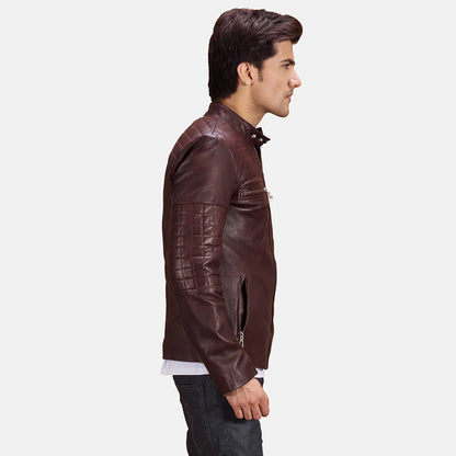 Front view of a man modeling a fully zipped deep brown leather jacket, highlighting the quilted shoulder panels and snap-button collar.