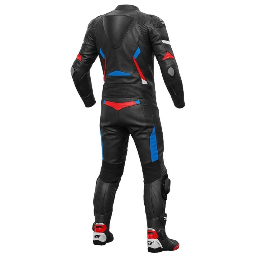 Detailed view of the Suzuki chest logo, royal blue technical panels, and red knee sliders on a professional track suit.