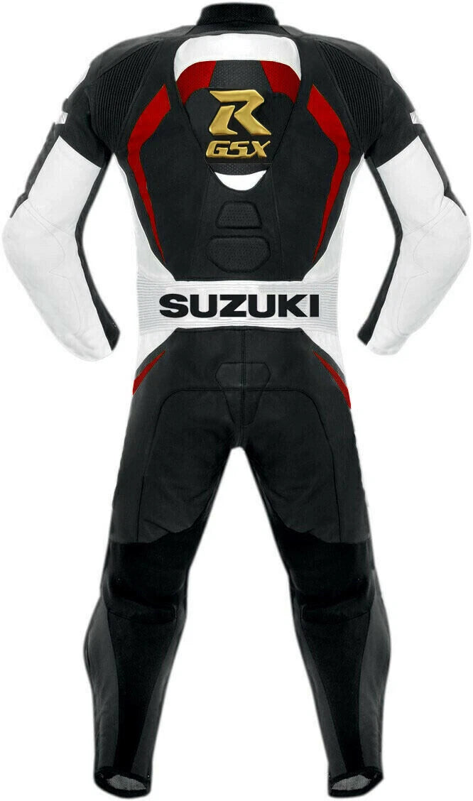 Detailed view of the gold Suzuki GSX logos, white Suzuki chest branding, and professional black knee sliders on a leather track suit.