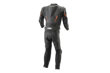 Detailed view of the KTM chest logo, dynamic padded torso plating, and professional track sliders on a black leather suit.
