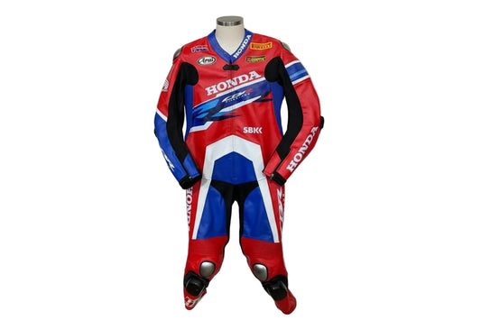 Honda CBR Fireblade one-piece leather racing suit in red, white, and blue with technical sponsor livery.