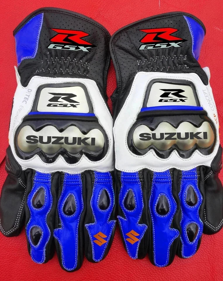 Suzuki GSX-R racing leather motorcycle gloves in blue, white, and black with metallic knuckle armor.