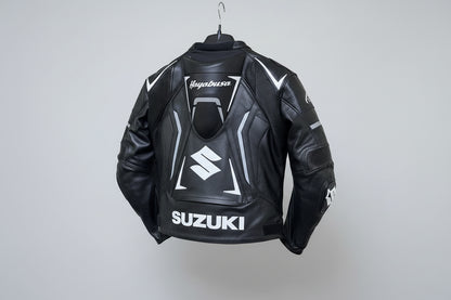 Detailed view of the white Hayabusa Kanji branding, Suzuki forearm logo, and external hard-shell shoulder sliders on a black leather jacket.