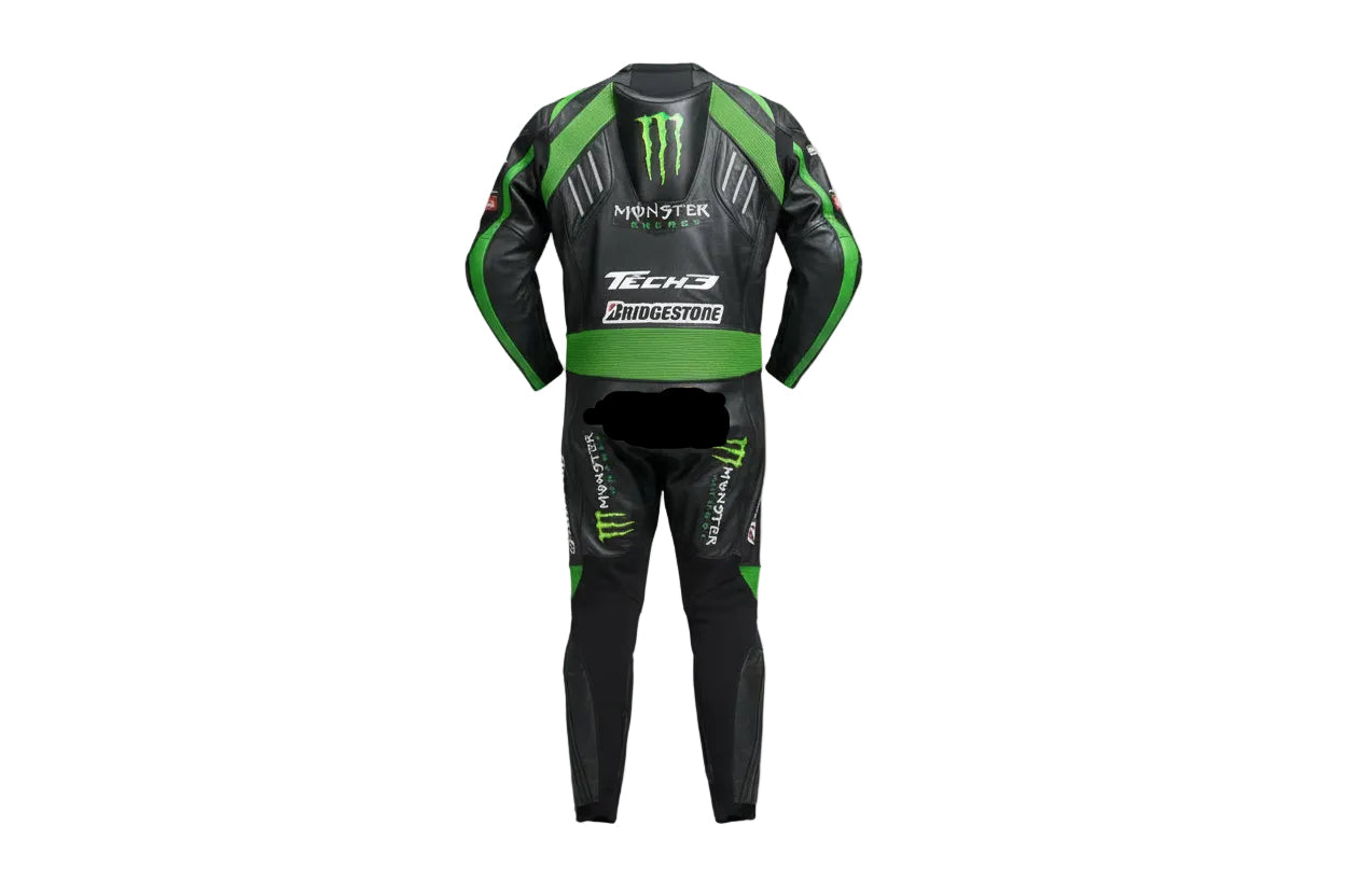 Detailed view of the Monster Energy claw logo, Tech3 forearm branding, and green accordion stretch panels on a professional one-piece racing suit.