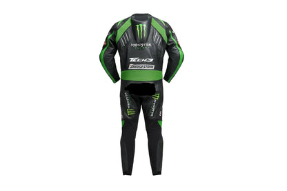 Detailed view of the Monster Energy claw logo, Tech3 forearm branding, and green accordion stretch panels on a professional one-piece racing suit.